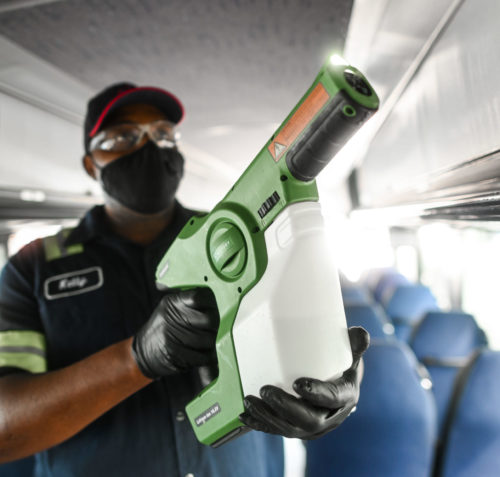 A Jefferson Lines employee uses an electrostatic disinfection sprayer