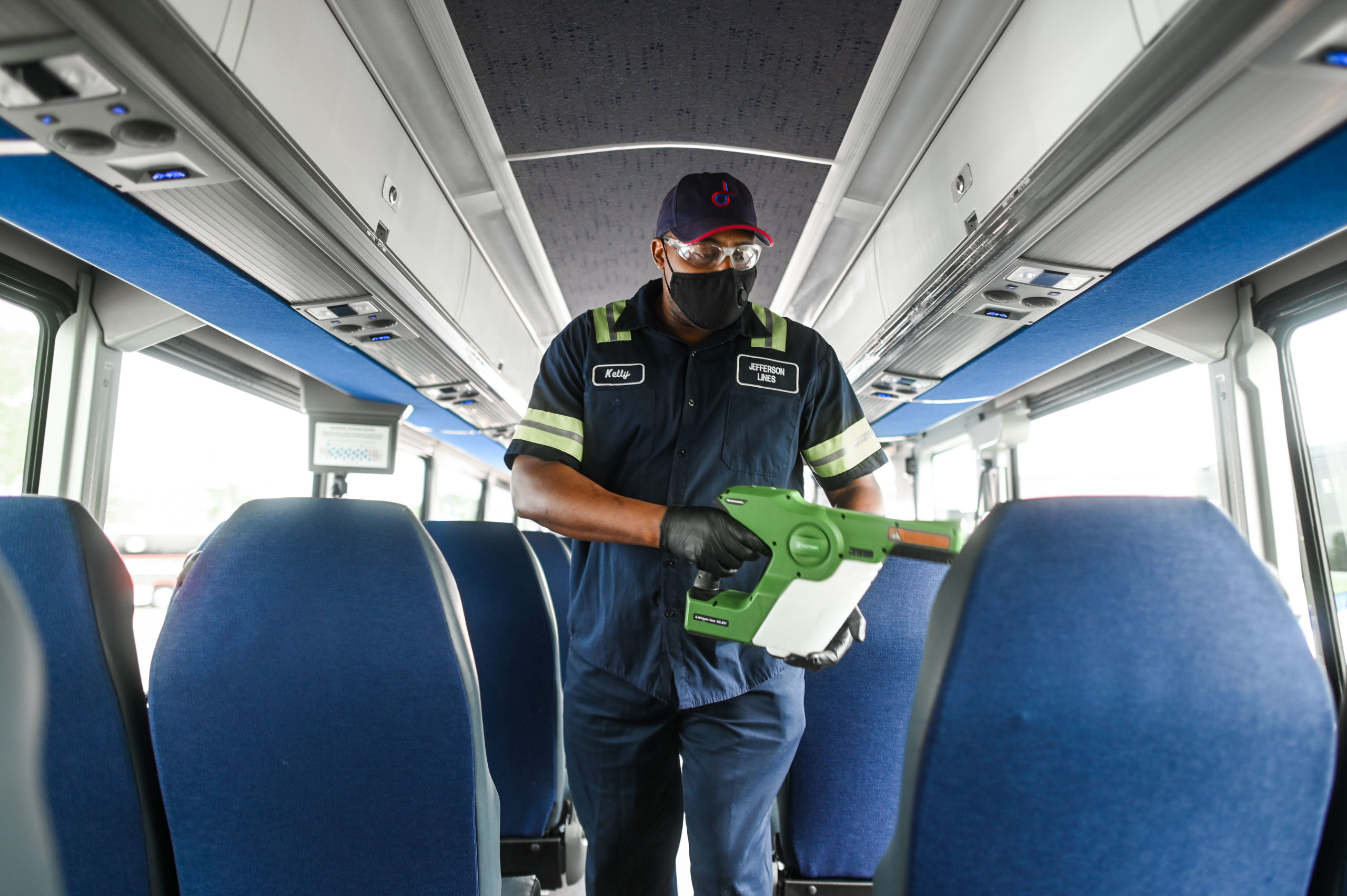 An employee uses an electrostatic cleaning device